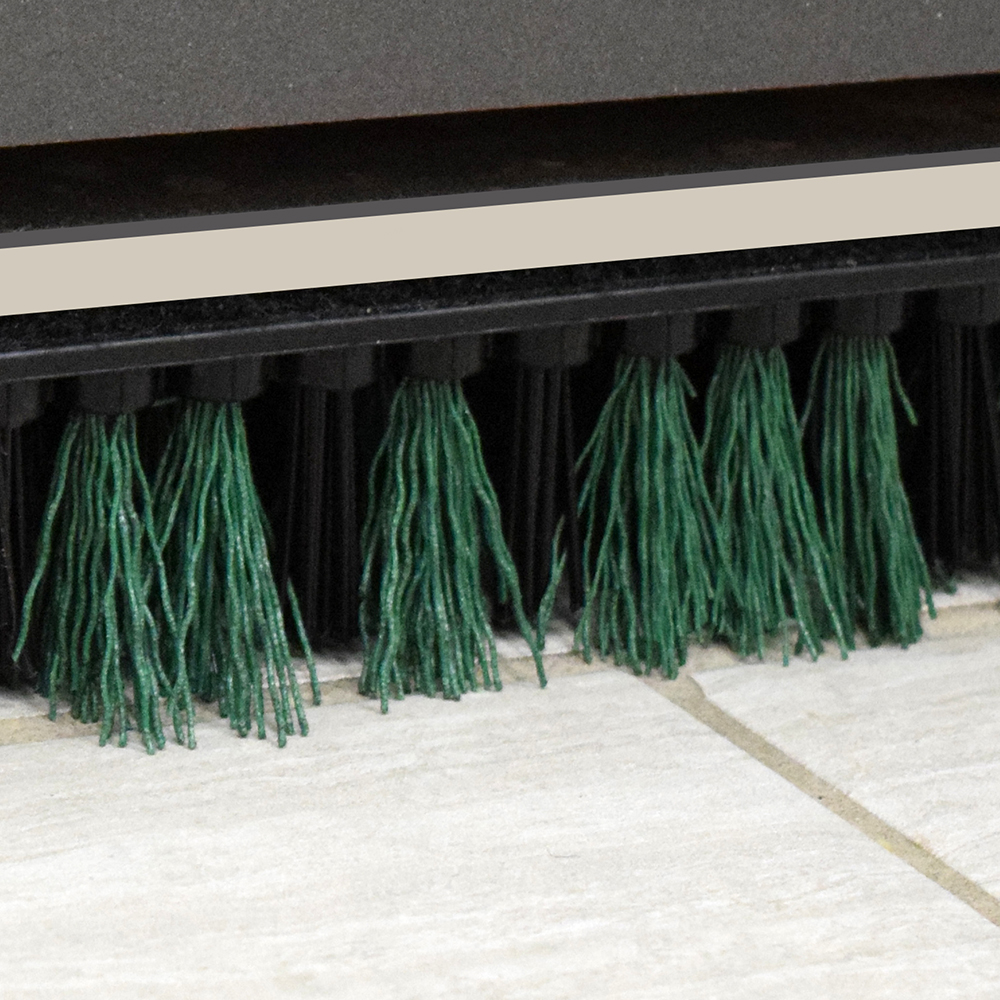 Green sonic scrub on grouted tile floor