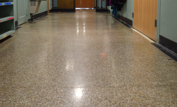 Shiny terrazzo floor that shows the light bulbs reflections from above