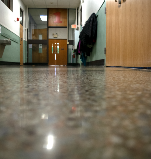 Reflective terrazzo floor that shows lights and the exit sign 