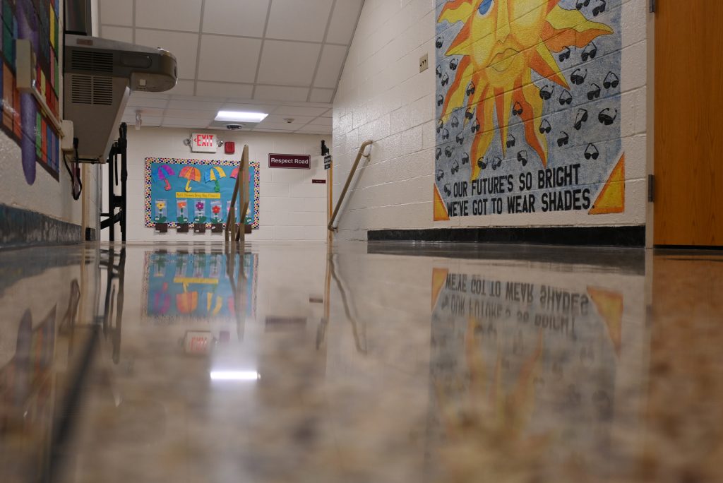 Shiny, reflective terrazzo floor that shows the colors and pictures on the wall, on the floor
