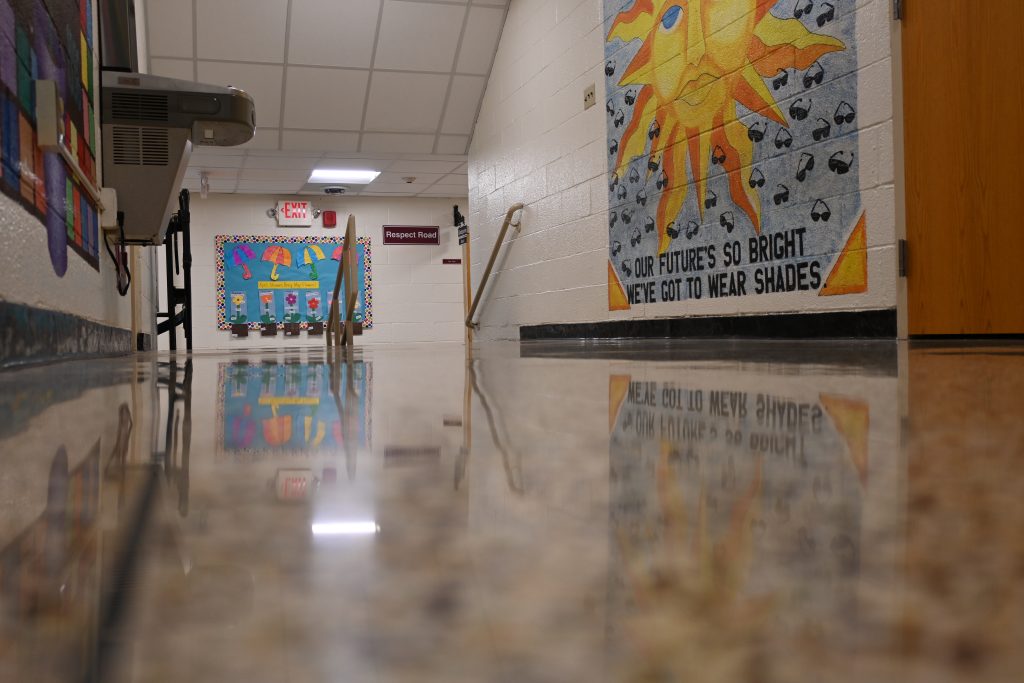 Super reflictive polished terrazzo floor with the reflection of wall murial