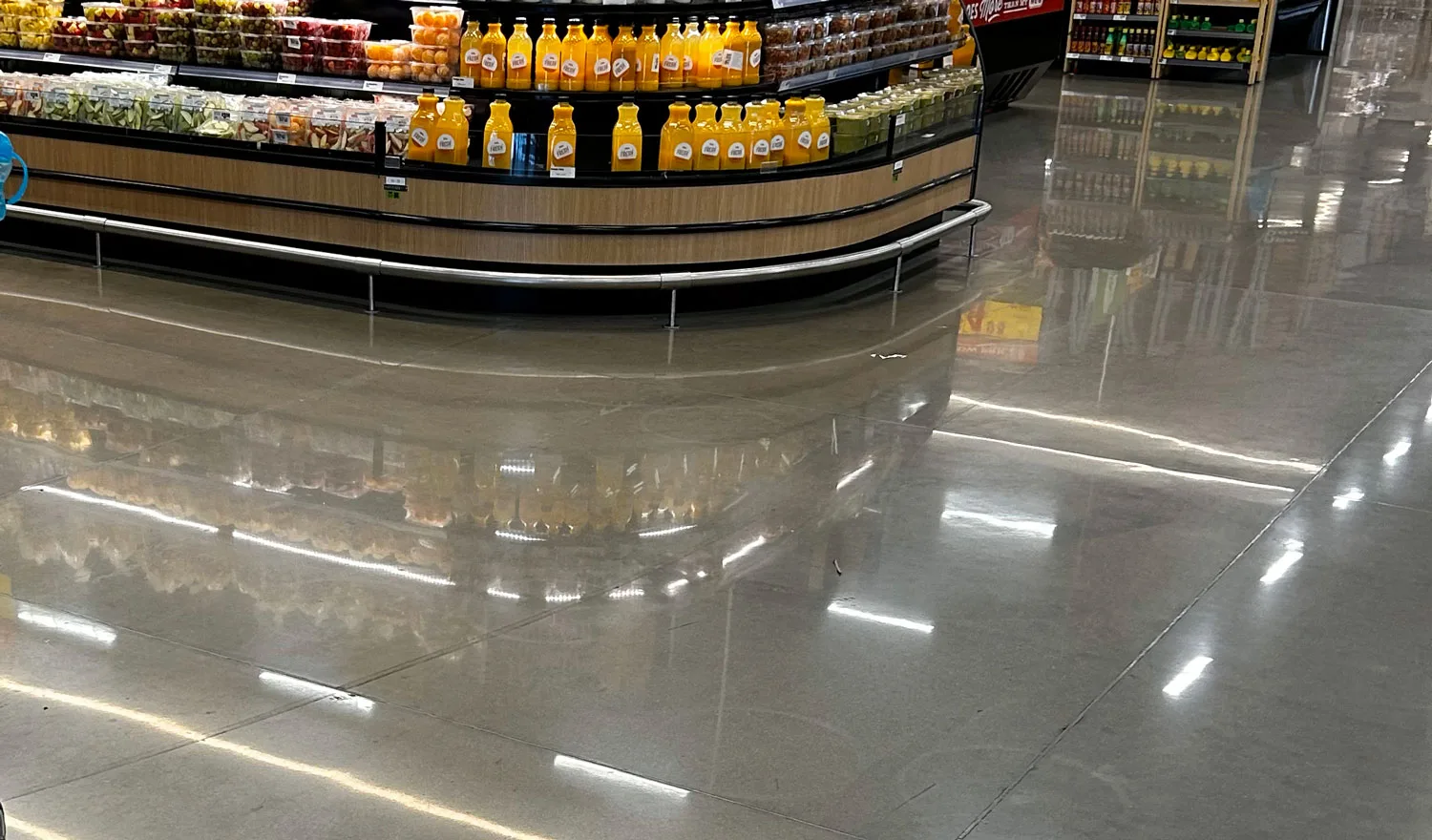 Shiny grocery store concrete with reflection of produce after Diamond Devil was used